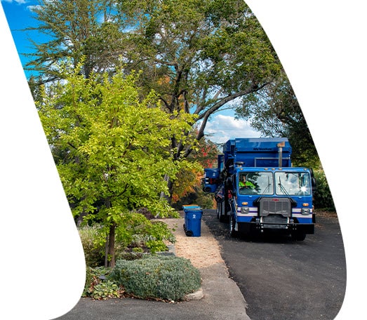 blue garbage truck on street