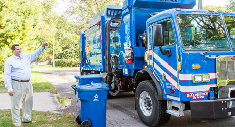 garbage truck picking up residential trash