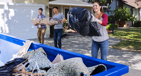 family filling a dumpster