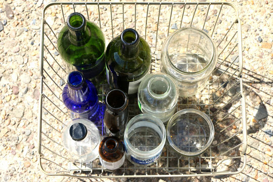 Glass Bottles in a Basket to be Recycled