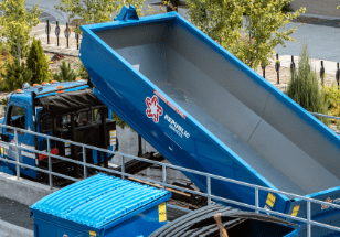 Roll-off dumpster being dropped off