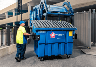 trash employee dropping off small dumpster