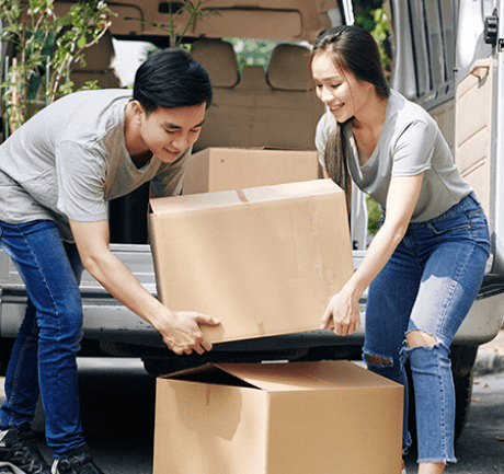Couple unloading moving boxes