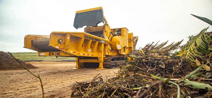 yellow grinder at compost facility