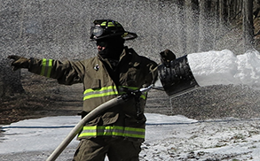 Fire fighter using hose