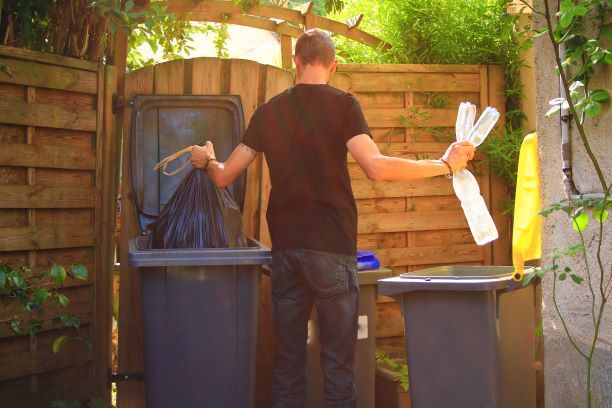 man throwing away trash