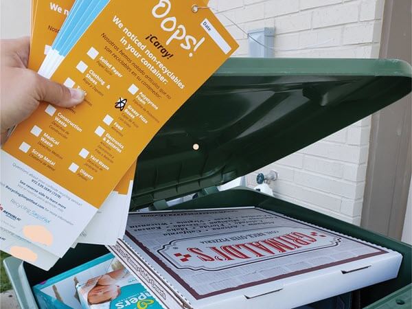 pizza box in a recycling bin