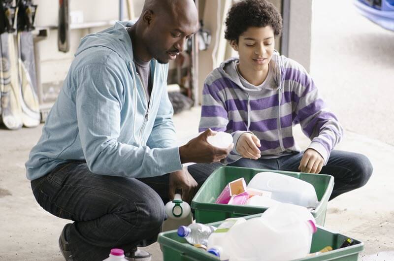 child and adult sorting recycling