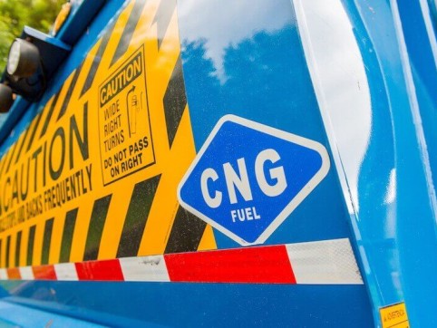 back of a blue truck with a caution sticker