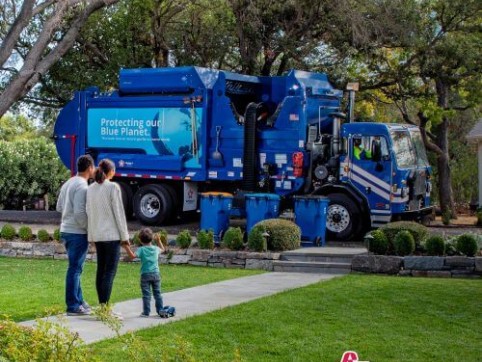 family watches the trash truck