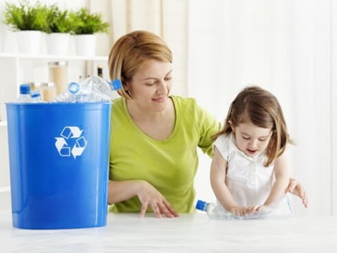 Mother and daughter learning to recycle