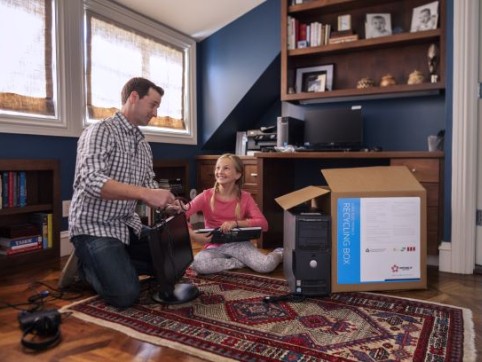 father and daughter filling up an electric waste box