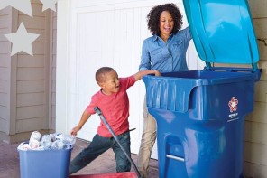 woman and child throwing recycling into Republic Services' recycling bin