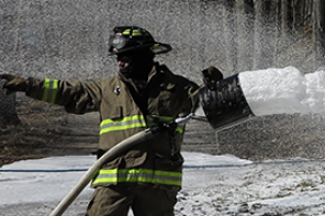 Fire fighter using hose 