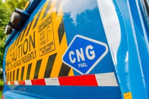 back of a blue truck with a caution sticker