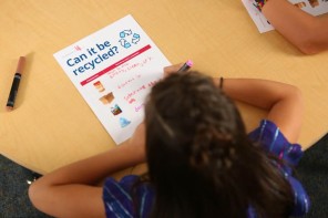 child learning to recycle