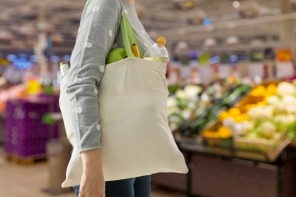 Reusable Grocery Bag on Shoulder of Woman in Grocery Store