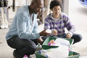 child and adult sorting recycling 