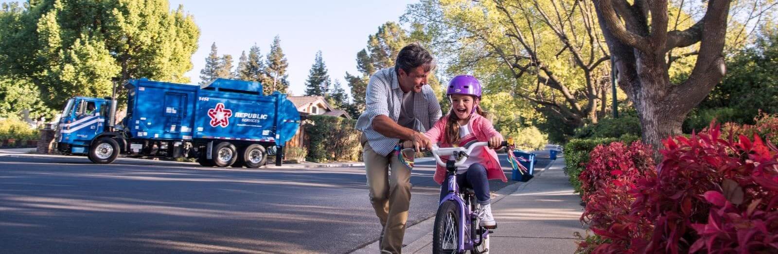 Republic Services Truck in Resi Neighborhood Dad and Daughter on Bike