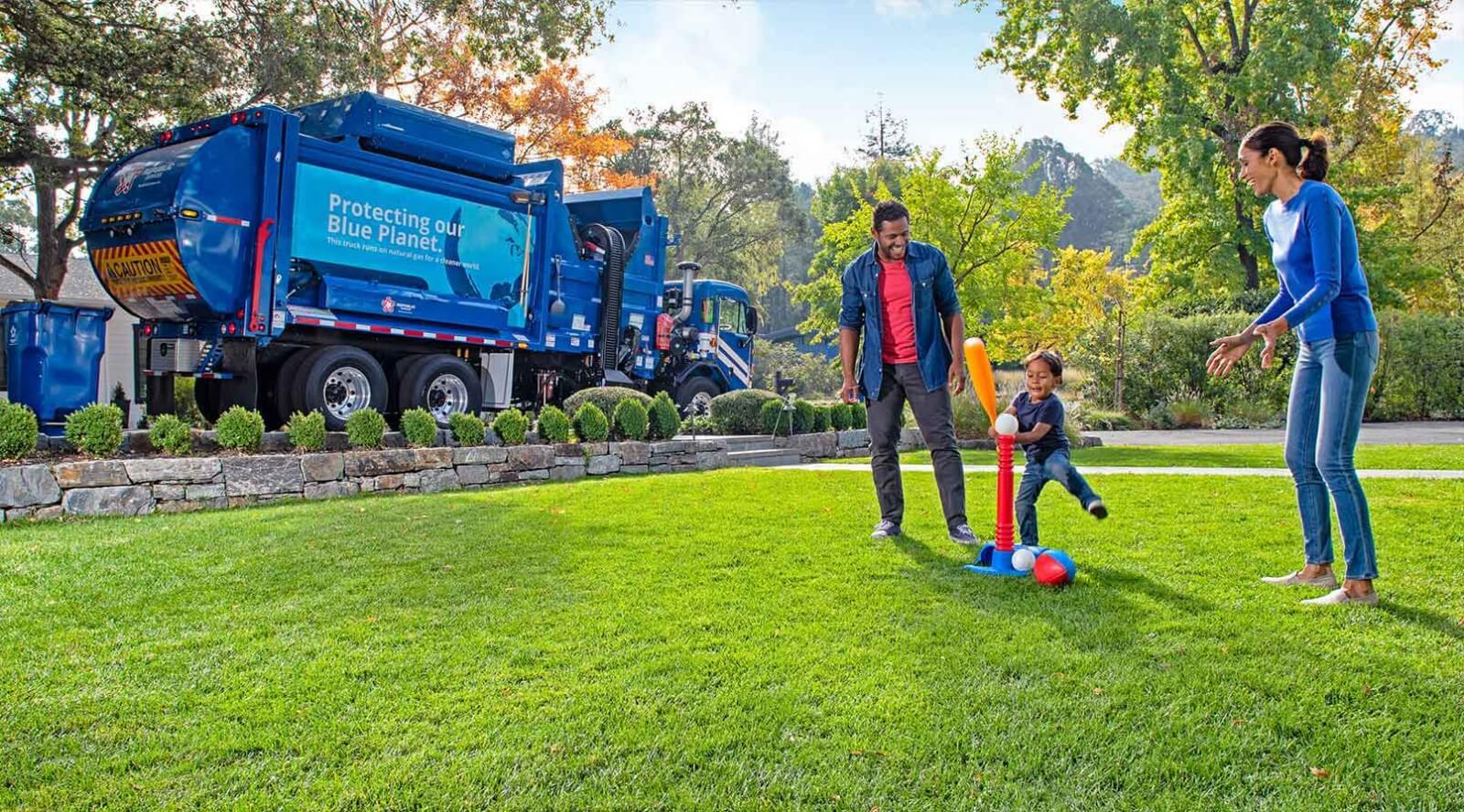 Family Playing in Yard with Republic Services Truck Behind