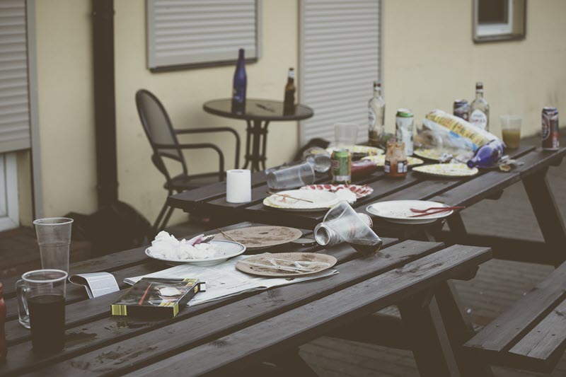 table with plates, cups, and leftover food