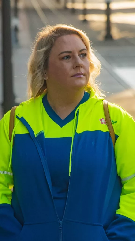 Employee wearing blue and hi-viz sweatshirt