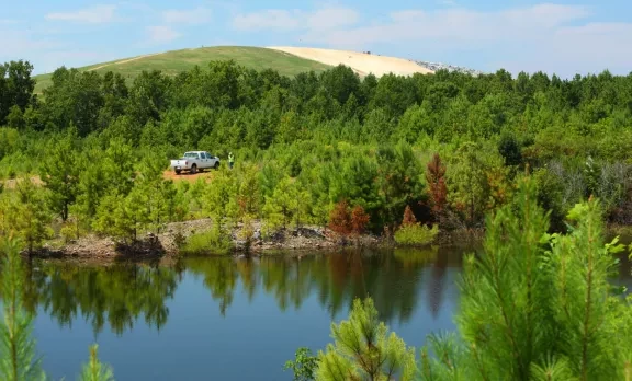 company vehicle near a reservoir