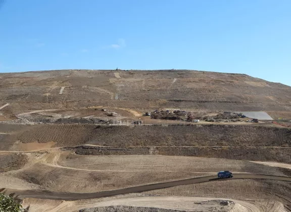 aerial shot of a landfill with trucks driving on designated dirt roads