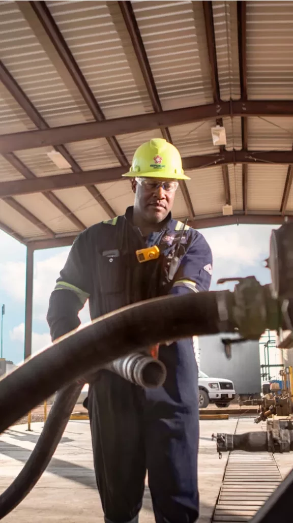 Employee connecting a large hose