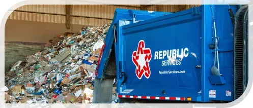 truck dumping recyclables onto the ground in a warehouse